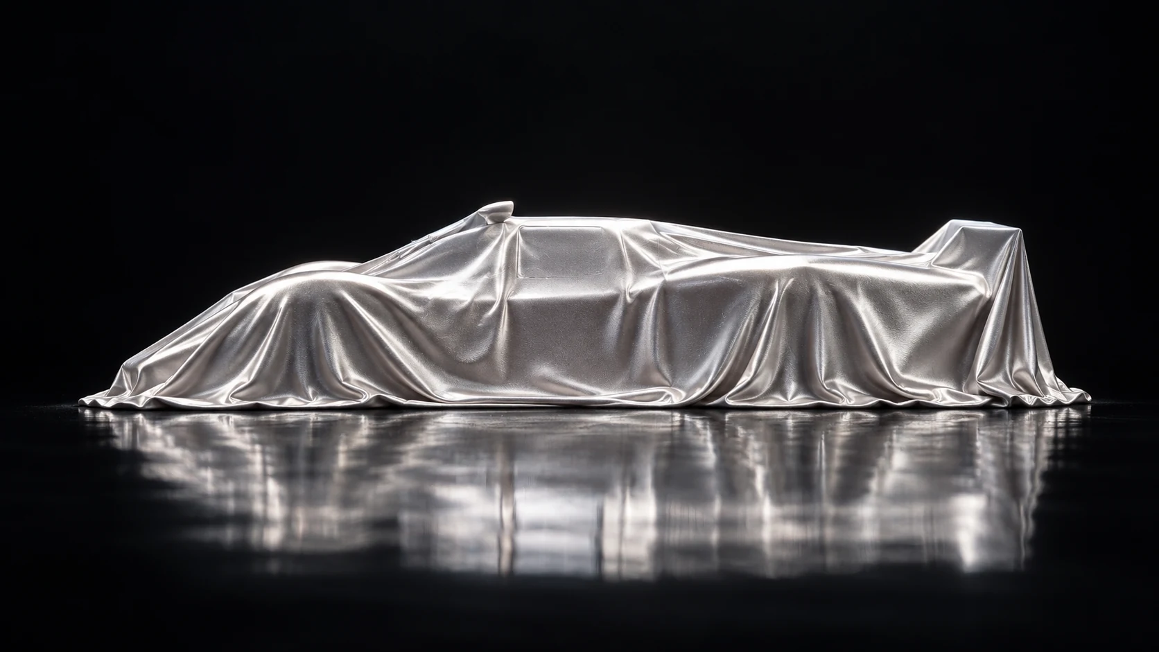 Concept of a car under a silver presentation cover